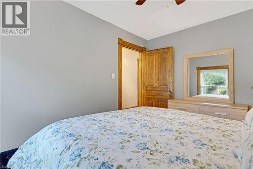 Bedroom featuring light gray walls, a wood-finish ceiling fan, and a paneled wooden door - 630 Lawrence Street, Cambridge, ON - Indoor Photo Showing Bedroom