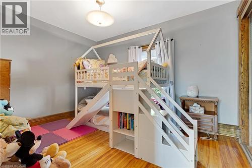 Light-toned wood-finish flooring complements the neutral wall color in this room, featuring a window with drapes - 630 Lawrence Street, Cambridge, ON - Indoor