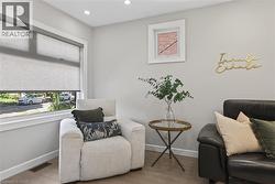 Recessed lighting illuminates an interior space featuring wood-finish flooring - 