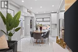 Dining area featuring marble-finish tile flooring, recessed lighting, and a built-in wine rack - 