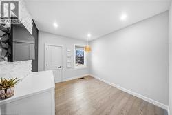 Unfurnished dining area featuring baseboards and light wood finished floors - 