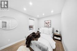Bedroom with wood finished floors and recessed lighting - 