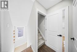 Stairs featuring wood finished floors and baseboards - 