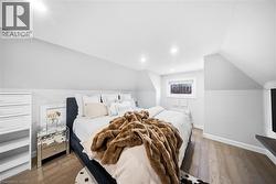 Bedroom featuring dark wood-type flooring and lofted ceiling - 