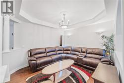 Tray ceiling with a central chandelier and wall sconces - 