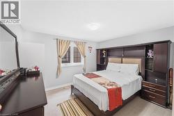 Recessed lighting illuminating a spacious room with light wood-finish flooring - 