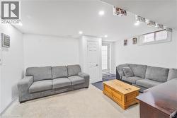 Finished living space featuring recessed lighting, a white painted door, a glass-panel door, a window, and light-colored carpeting - 