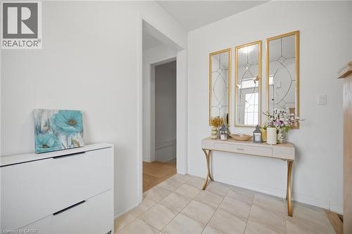 Tiled entryway featuring a decorative console table and a set of three framed mirrors - 240 Velvet Way, Niagara Falls, ON - Indoor Photo Showing Bathroom