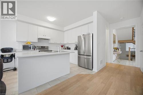Contemporary kitchen featuring white cabinetry, a central island, and stainless steel appliances - 240 Velvet Way, Niagara Falls, ON - Indoor Photo Showing Kitchen