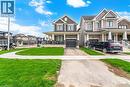 Modern two-story residence featuring a dark gray facade, white columned porch, and an attached single-car garage - 240 Velvet Way, Niagara Falls, ON  - Outdoor With Deck Patio Veranda With Facade 