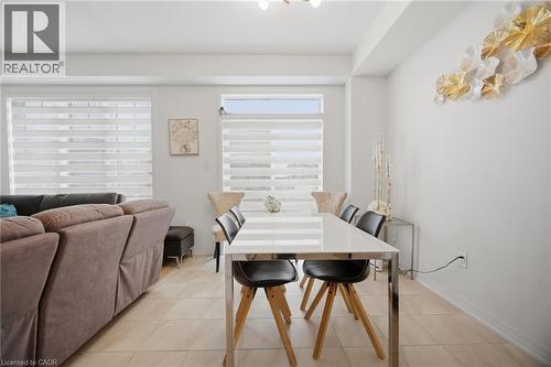 Open concept living and dining area featuring light-toned tile flooring, recessed lighting, and large windows with privacy blinds - 240 Velvet Way, Niagara Falls, ON - Indoor Photo Showing Dining Room