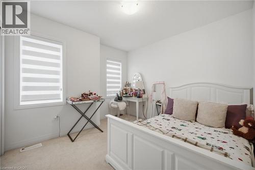 Bright room featuring two windows with horizontal blinds, white walls, and neutral carpet flooring - 240 Velvet Way, Niagara Falls, ON - Indoor Photo Showing Bedroom