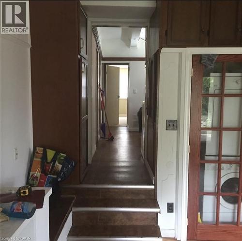 yard level family room with stackable washer and dryer area and stairs to 3rd floor - 456 Jackson Street W, Hamilton, ON - Indoor Photo Showing Other Room
