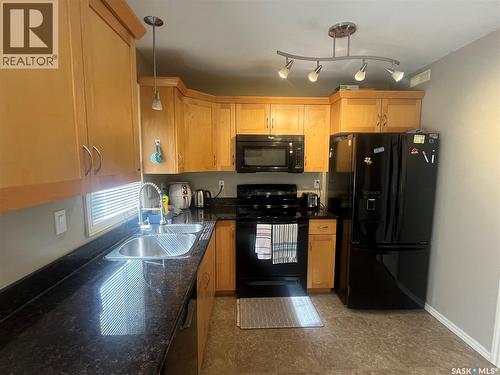 207 303 Slimmon Place, Saskatoon, SK - Indoor Photo Showing Kitchen With Double Sink