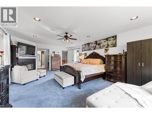 3257 Juniper Drive, Naramata, BC - Indoor Photo Showing Bedroom With Fireplace