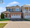 Contemporary two-story residence featuring a brick and siding exterior, an integrated single-car garage, and a covered front porch - 60 Postmaster Drive, Kitchener, ON  - Outdoor With Facade 