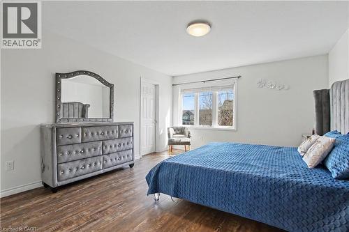 Spacious room featuring wood-finish flooring, white walls, and a ceiling-mounted light fixture - 60 Postmaster Drive, Kitchener, ON - Indoor Photo Showing Bedroom