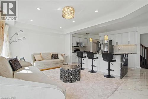 Open-concept living space featuring recessed lighting and a decorative chandelier - 60 Postmaster Drive, Kitchener, ON - Indoor Photo Showing Other Room