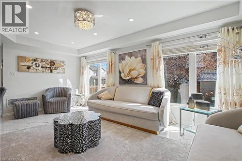 Living area featuring recessed lighting, a decorative ceiling fixture, and tray ceilings - 60 Postmaster Drive, Kitchener, ON - Indoor Photo Showing Living Room