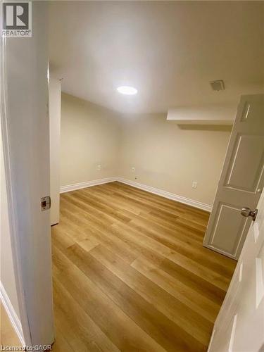 Room featuring wood-finish flooring, recessed lighting, neutral wall tones, and white trim - 63 Audrey Street, Hamilton, ON - Indoor Photo Showing Other Room