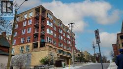 Multi-story residential building featuring red brick and light-colored siding - 
