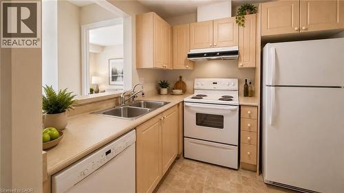 Kitchen featuring light wood-finish cabinetry, white appliances, and a double basin stainless steel sink. Virtually Staged - 20 St. George Street Unit# 404, Kitchener, ON - Indoor Photo Showing Kitchen With Double Sink