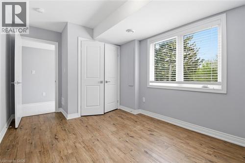 Room featuring wood-finish flooring, light grey walls, white baseboards, and white trim - 3 Hagar Street, Thorold, ON - Indoor Photo Showing Other Room