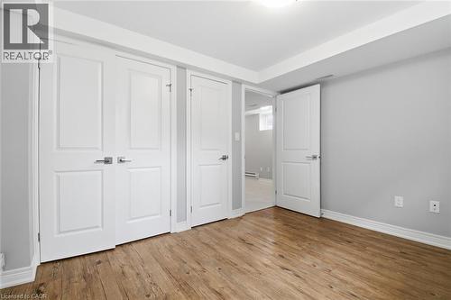 Room with wood-finish flooring, light gray walls, and white baseboards - 3 Hagar Street, Thorold, ON - Indoor Photo Showing Other Room