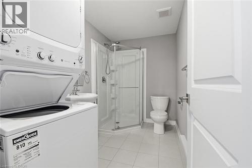 Full bathroom featuring a corner shower, pedestal sink, and white ceramic tile flooring - 3 Hagar Street, Thorold, ON - Indoor Photo Showing Laundry Room