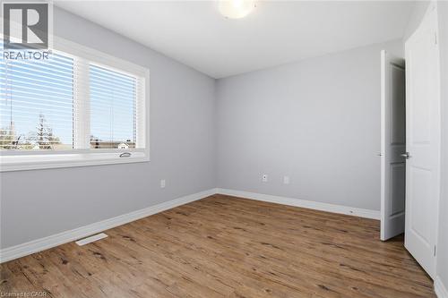Bright room featuring wood-finish flooring, light grey walls, and white trim - 3 Hagar Street, Thorold, ON - Indoor Photo Showing Other Room