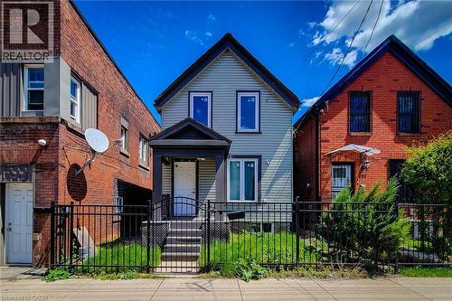 Light blue siding exterior with a dark gray porch and gabled roof - 334 Gage Avenue N, Hamilton, ON - Outdoor With Facade