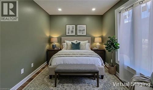 Spacious room featuring wood-finish flooring and a large window with sheer drapes - 334 Gage Avenue N, Hamilton, ON - Indoor Photo Showing Bedroom