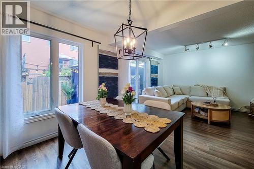 Open-concept living area featuring dark wood-finish flooring - 7 Davidson Boulevard Unit# 14, Dundas, ON - Indoor