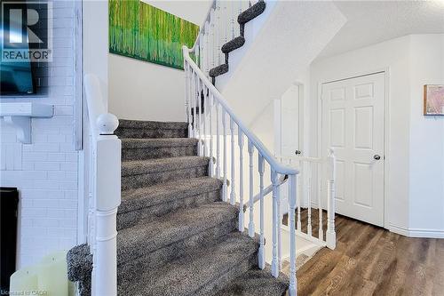 Carpeted staircase featuring white balusters and handrails - 7 Davidson Boulevard Unit# 14, Dundas, ON - Indoor Photo Showing Other Room
