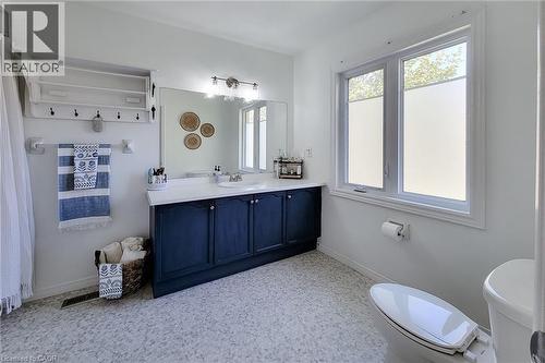 Bathroom featuring a dual-sink vanity with a dark blue cabinet base and white countertop - 7 Davidson Boulevard Unit# 14, Dundas, ON - Indoor Photo Showing Bathroom
