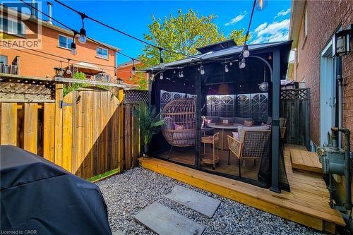 Enclosed outdoor gazebo featuring a wood-finish deck base and string lighting - 7 Davidson Boulevard Unit# 14, Dundas, ON - Outdoor