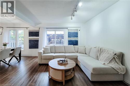 Living area featuring dark wood-finish flooring, white walls, and a recessed ceiling element - 7 Davidson Boulevard Unit# 14, Dundas, ON - Indoor Photo Showing Living Room