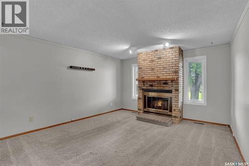 1409 Rothwell Street, Regina, SK - Indoor Photo Showing Living Room With Fireplace