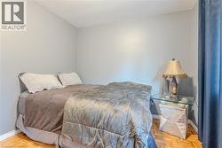 Herringbone wood-finish flooring complements light gray walls - 