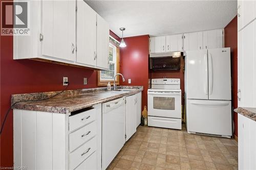 Kitchen featuring extensive white cabinetry, a built-in microwave, white electric range, and a white French door refrigerator - 162 Tiffany Street, Cambridge, ON - Indoor Photo Showing Kitchen