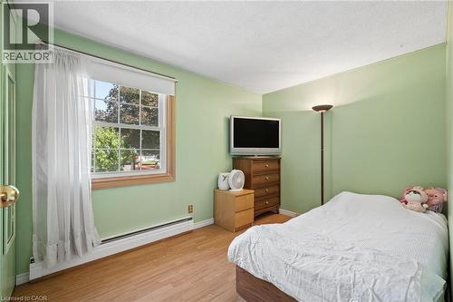 Room featuring light green walls and wood-finish flooring - 162 Tiffany Street, Cambridge, ON - Indoor Photo Showing Bedroom