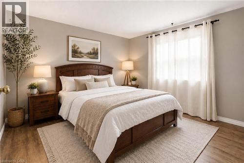 VIRTUALLY STAGED. Bedroom featuring wood-finish flooring, a window with sheer curtains, and light neutral wall paint - 162 Tiffany Street, Cambridge, ON - Indoor Photo Showing Bedroom