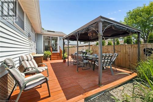 Expansive stained wood deck featuring a covered gazebo, sliding glass door access, light blue siding, and a privacy fence - 162 Tiffany Street, Cambridge, ON - Outdoor With Deck Patio Veranda