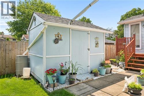 Detached shed with light blue siding, white trim, and a shingled roof - 162 Tiffany Street, Cambridge, ON - Outdoor With Exterior