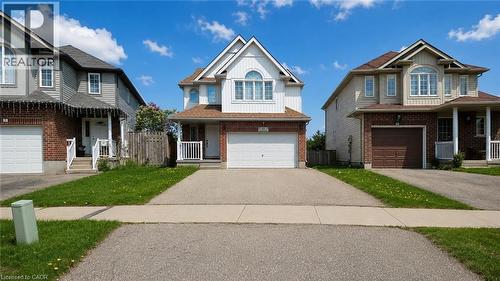 Two-story residence featuring a white siding upper level and a brick lower level - 10 Doll Court, Kitchener, ON - Outdoor With Facade