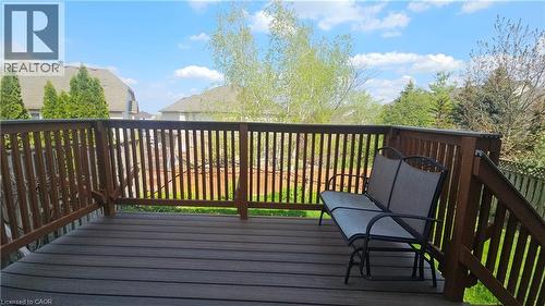 Spacious outdoor deck featuring wood-finish composite decking and matching wood railing - 10 Doll Court, Kitchener, ON - Outdoor With Deck Patio Veranda