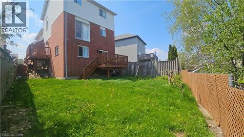 Expansive backyard with a sloped lawn and natural perimeter fencing - 10 Doll Court, Kitchener, ON - Outdoor With Deck Patio Veranda