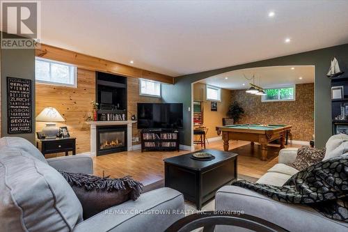 Lower level recreation area - 5 Pine Hill Drive, Springwater, ON - Indoor Photo Showing Living Room With Fireplace