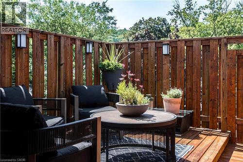 Deck area featuring rich wood decking and a surrounding privacy fence with integrated wall sconces - 165 Markland Street, Hamilton, ON - Outdoor With Deck Patio Veranda With Exterior