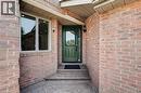 Brick exterior featuring a green entry door with decorative glass and sidelight - 3346 Chartrand Crescent, Mississauga, ON  - Outdoor With Exterior 